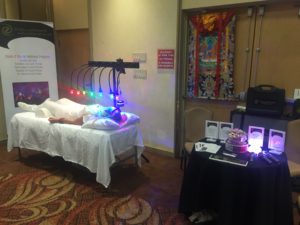 Far from person receiving energy healing on StellarWaves crystal bed